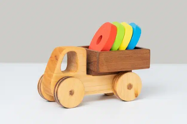 wooden toy truck with colored rings back grey background 182793 2637
